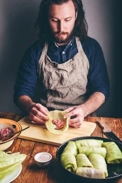 Man Cooking Cabbage Rolls Stuffed with Meat Stock Photos