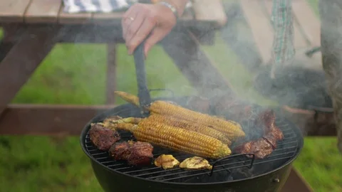 Man cooking corn on the grill Stock Footage 91233443