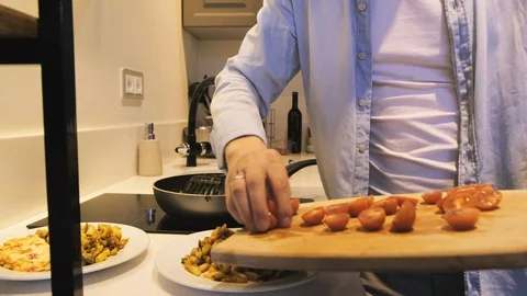 Man Cooking Dinner At Home Stock Footage 130003657
