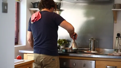 Man Cooking Eggs And Bacon Stock Footage 97441382