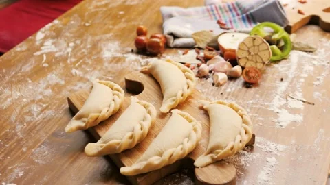 Man cooking empanadas argetinian pie, traditional bakery from argentina, chef Stock Footage 133786245