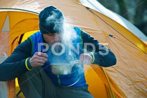 Man Cooking Food By Camping Tent