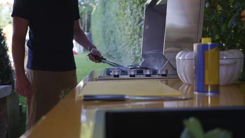 A man is cooking on a grill Stock Footage 297871607