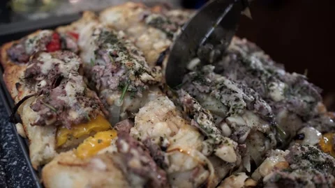 Man Cooking Having Trouble Cutting Lamb Pizza in Squares Stock Footage 142487031