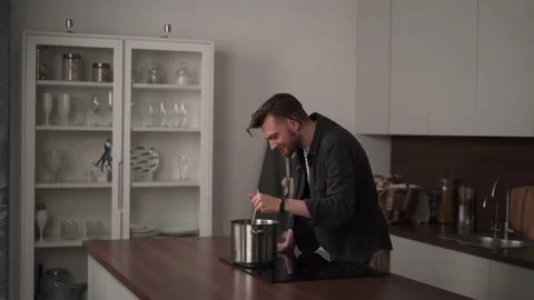 Man cooking in the kitchen Stock Footage 169049376