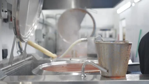 A man is cooking in a kitchen with a pot of boiling water Stock Footage 297840627