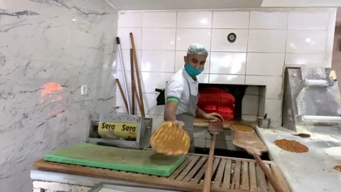 Man cooking lahmacun in an open fire oven Vidéo 149113642