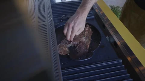 A man is cooking meat on a grill Stock Footage 297871494