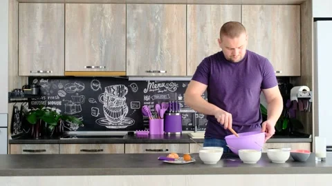 Man cooking in modern kitchen alone preparing pie cake Stock Footage 208837401