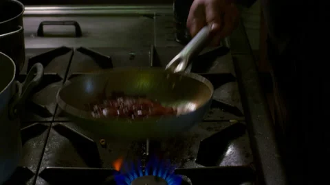 Man cooking onions in pan Stock Footage 233764487