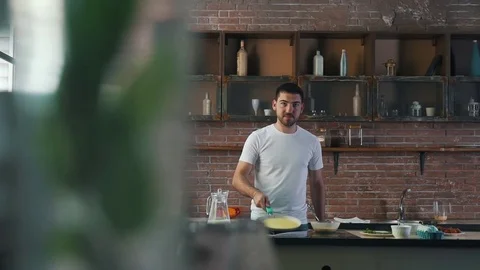 The man is cooking pancakes Stock Footage 79114189