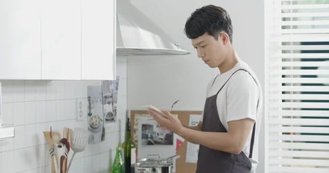 Man cooking with recipe of notes Stock Footage 100944273