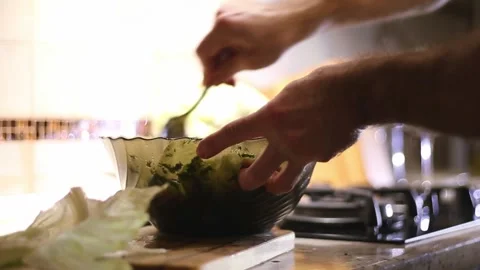 A man is cooking a salad Stock Footage 311023399