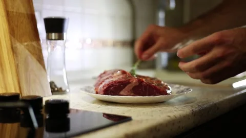 Man cooking steak at home Stock Footage 311164553