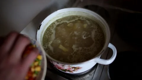 Man is cooking vegetable soup Video stock 137295867