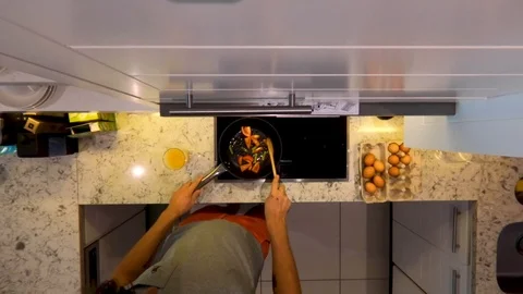 A man cooks breakfast in the kitchen. Stock Footage 101632548