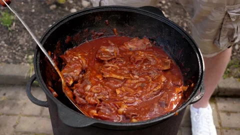 A man cooks fried meat in a pan with sauce and beer. 4K shooting Stock-Footage 131875985