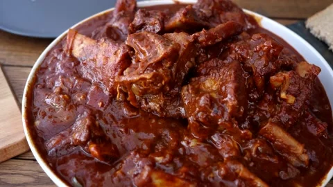 A man cooks fried meat in a pan with sauce and beer. 4K shooting Video stock 131876114