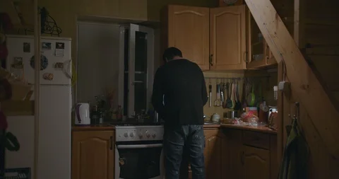 Man cooks in the kitchen and makes tea Stock Footage 120837204