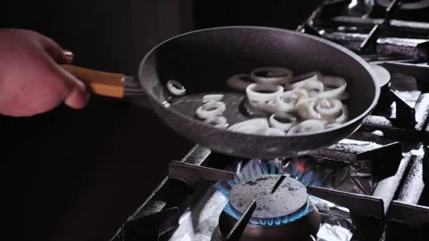 Man Cooks a Simple Meal Preparing Dish in a Pan - Searing onions Видео 151406205