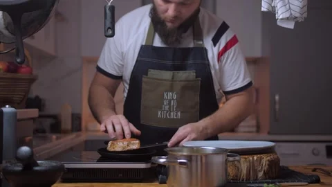 A man cooks tuna in a kitchen Stock Footage 258735347
