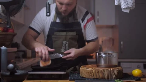 A man cooks tuna in a kitchen Stock Footage 258735405