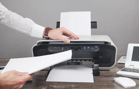 Man copying and scanning documents in office. Stock Photos