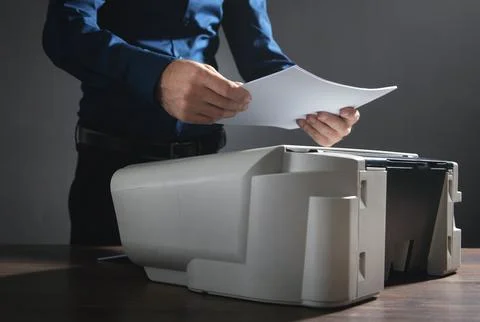 Man copying and scanning documents in office. Stock Photos