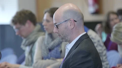 Man at a corporate event typing on Macbook laptop Stock Footage 64566211