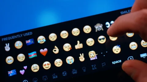 The man is in correspondence sends smiley on a Tablet PC. Stock Footage 62890184