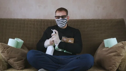 The man on the couch. Antiseptic injects in different directions. Stock-Footage 128140202