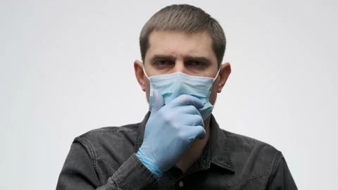 Man coughing and covers his mouth with a gloved hand. Stock Footage 141017363