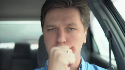 The man is coughing in the car. Stock Footage 81833511