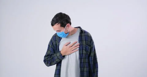 Man coughing in protective face mask and covering mouth Stock Footage 143943952