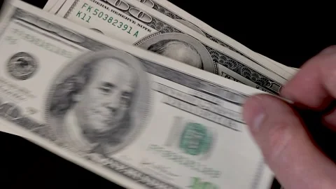 Man counting 100 dollar bills in stack on table Video stock 221651280