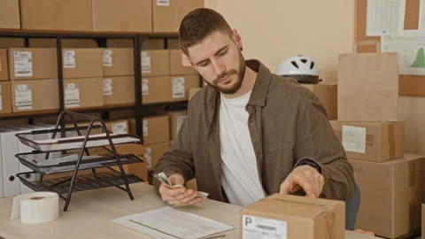 Man counting cash with hands among parcels on desk in building mailroom, ho.. Stock Footage 337364738