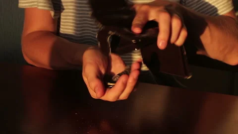 Man counting coins at the table and an empty wallet Stock Footage 99877959