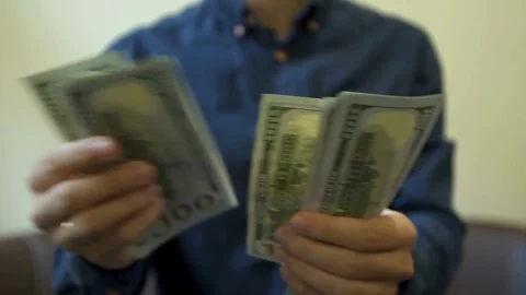 A man is counting dollar banknotes. Man holds cash in hands. economy and fi.. Stock Footage 266470199