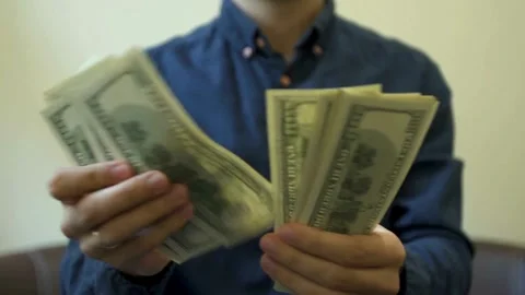 A man is counting dollar banknotes. Man holds cash in hands. economy and fi.. Stock Footage 266470317