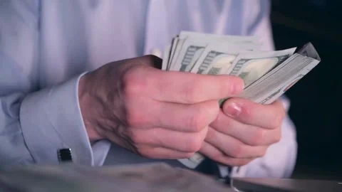 A man is counting dollar banknotes. Man holds cash in hands. economy and finance Stock-Footage 336259617