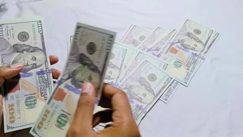 Man counting dollar bill salary Stock Footage 285572048