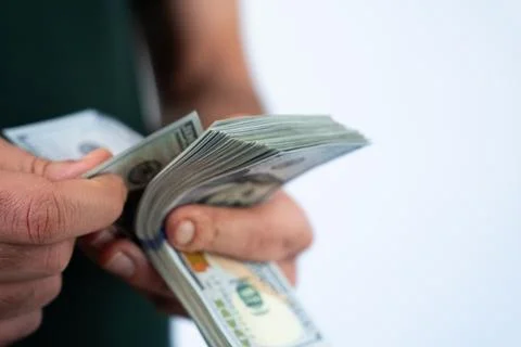 Man counting dollar bills in hands Stock Photos