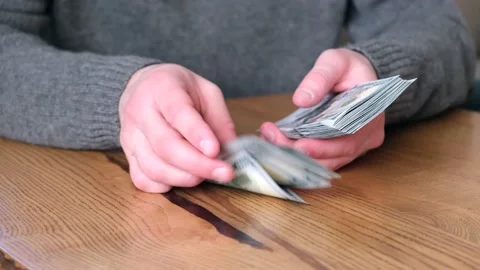 Man counting dollar cash. Counting money concept 15.04.2022 Minsk, Belarus Stock Footage 186498017