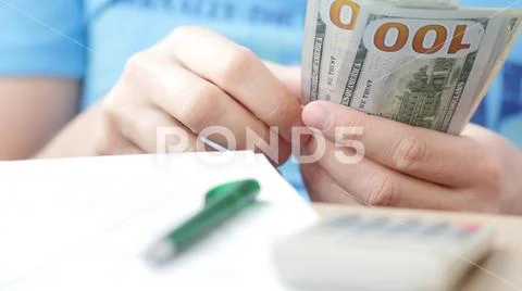 Man counting dollars and filling tax form. Stock Photos