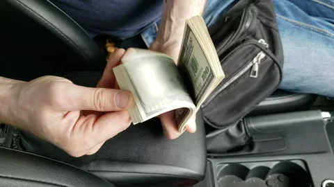 Man counting dollars in car number № 4 Stock Footage 242264751