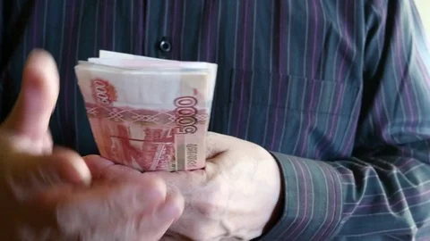 Man Counting Five Thousand Rubles. Russian Banknotes. Sunny Day. Video stock 69926306