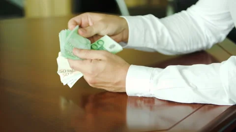 Man counting large stack of banknotes Stock Footage 63298963