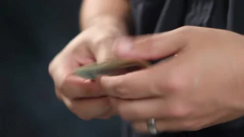 Man counting a large stack of USA currency by both hands. Man holds cash in.. Stock Footage 266476362