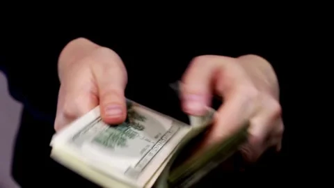 Man counting a large stack of USA currency by both hands. Man holds cash in Stock-Footage 336264153