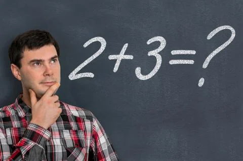 Man is counting a mathematical task on blackboard - education concept Stock Photos